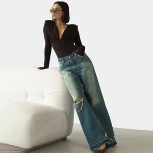Chic long sleeve deep V-neck bodysuit paired with distressed wide-leg blue jeans for women