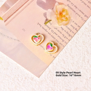 Detailed macro of 16x16mm heart-shaped peach charms with pearls on vintage background