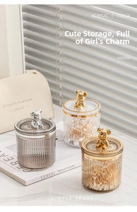 Detailed view of luxury acrylic storage jars with decorative gold and silver metal bears
