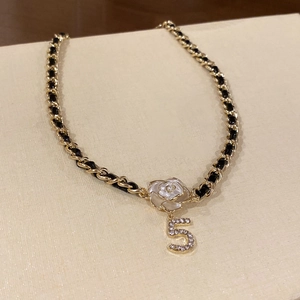 Elegant gold metal and black leather woven necklace with white camellia flower and number 5 charm