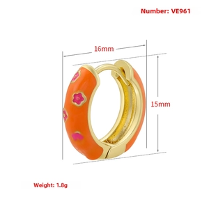 Detailed view of orange enamel hoop earrings with pink flower patterns and 18K gold plating