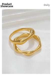 Detailed view of two irregular wavy gold plated rings on white tiered display stand