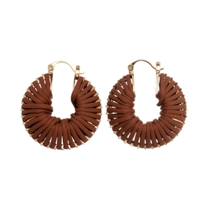 Retro woven brown leather and gold metal hollow hoop earrings for women on white backdrop