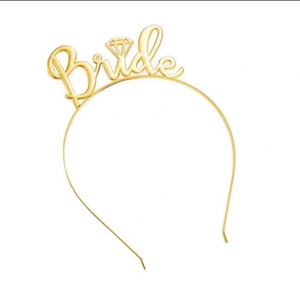 Close-up of golden Bride metal headband with diamond design for bridal parties