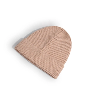 Detail of soft pink knit beanie showing high-quality thick wool texture and folded cuff
