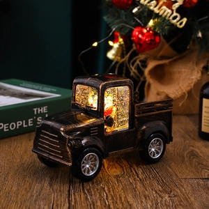 Close-up of vintage bronze Christmas truck lantern with glitter water and LED light