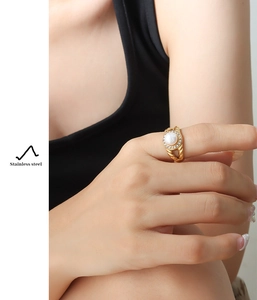 Detail of 18K gold-plated stainless steel ring featuring freshwater pearl and cubic zirconia