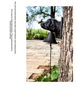 Close-up of antique brown cast iron dog head door bell with rustic wall-mounted detail