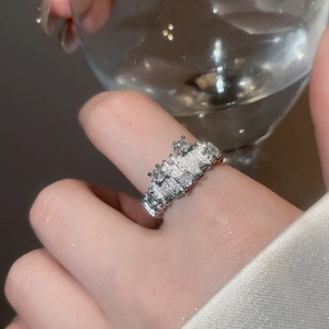 Detailed view of silver geometric open ring with sparkling cubic zirconia on finger