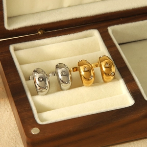 Polished teardrop stud earrings in gold and silver finish with sparkling star-set stones