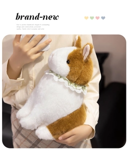 Close-up of cute plush bunny with green lace collar held by hands to show soft texture