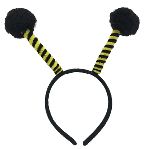 Close-up of yellow and black bee headband with fluffy antennas for party costume