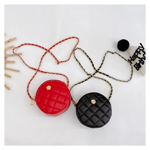 Detail of mini quilted round bags with gold flower clasps and woven chain straps