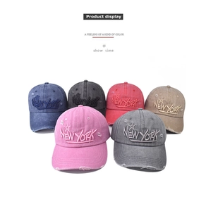 Close-up of vintage washed cotton baseball caps in six colors with New York embroidery