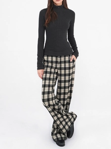 Detail of slim-fit charcoal half-zip sweatshirt paired with plaid wide-leg trousers