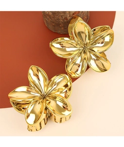 Detailed view of two gold floral metal hair claws with glossy finish and secure grip teeth