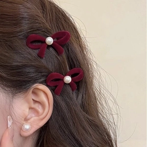 Red flocked velvet bow hair clips with center pearl accent for women's hairstyle