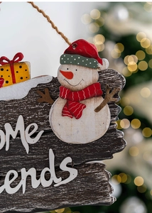 Macro detail of wooden Christmas snowman welcome sign with textures and festive bokeh