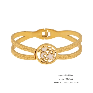 Detail view of a gold stainless steel layered bangle with heart and floral motifs