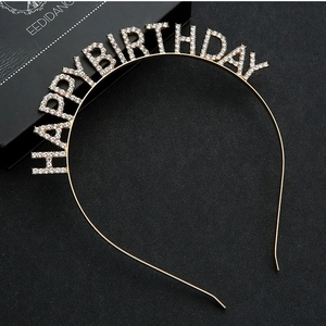 Close-up of gold metal Happy Birthday headband with sparkling white rhinestones