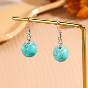 Detailed macro shot of vintage turquoise bead drop earrings with natural brown texture