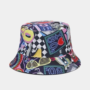 Detail view of colorful graffiti bucket hat with retro 80s cassette and rainbow patterns