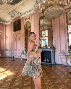 Detail of floral chiffon off-shoulder dress with ruffled sleeves in a palace setting