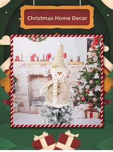 Close-up of a festive Christmas snowman plush decoration with knitted hat on a mini tree