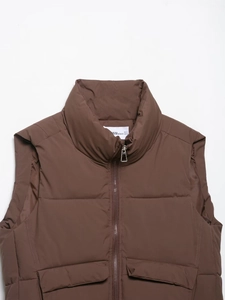Close-up of brown sleeveless puffer vest featuring a stand collar and full front zipper