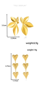 Detail view of gold stainless steel petal earrings and triple heart drop with dimensions