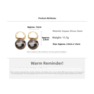 Detail view of retro resin orb earrings with gold zircon hoops showing size parameters