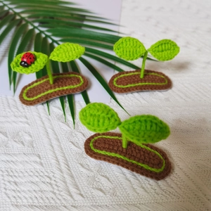 Handmade crochet green sprout hair clips with cute ladybug detail for baby girls