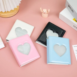 Detail of 3-inch heart cutout photo albums in white, pink, black, and blue finishes