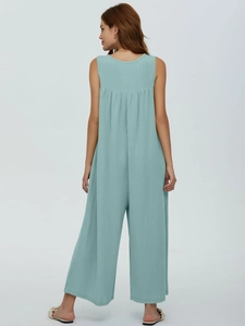 Macro shot of mint green ribbed knit fabric and U-back design of the wide-leg jumpsuit