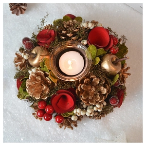 Detailed top view of Christmas candle holder with pine cones berries and white candle
