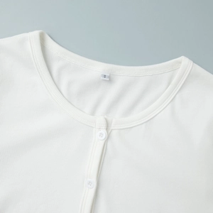 Detail of white ribbed knit cardigan collar with buttons and small size S label