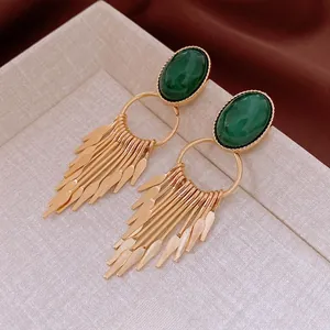 Vintage gold-toned tassel earrings with deep green oval resin stones in court style