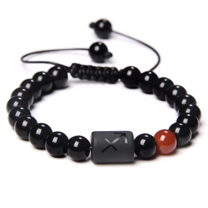 Braided black beaded bracelet featuring a Sagittarius zodiac symbol and adjustable cord