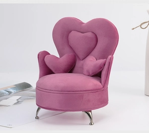 Detail of a purple velvet heart-shaped sofa jewelry box with silver metal legs
