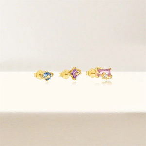 Close-up of gold S925 earrings with blue purple pink zircons and star details