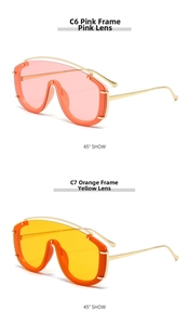 Detail view of pink and orange wrap-around shield sunglasses with thin metal temples