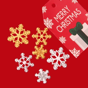 Golden and silver glitter snowflake pendants with Merry Christmas gift tag on red background