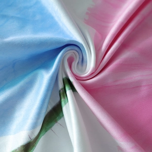 Detailed macro view of soft floral print fabric with blue and pink gradient patterns