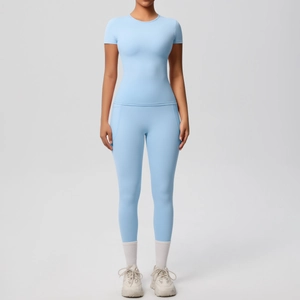 Front view of light blue high-stretch yoga set with slim-fit short sleeves and side pockets