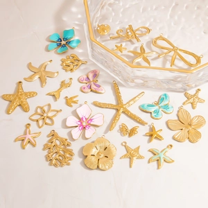 Detailed macro view of colorful enamel starfish and butterfly charms with gold finish
