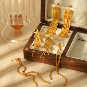Three pairs of elegant 18k gold-plated stainless steel tassel earrings on a wooden jewelry box