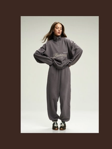Dark gray two-piece tracksuit set with half-zip sweatshirt and loose sports pants