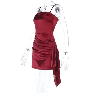 Detail of ruched burgundy satin mini dress with elegant side draped asymmetric design