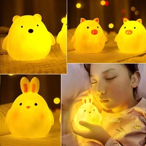 Detail showing cartoon bunny bear and pig night lights with warm yellow glowing effect