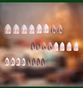 Detail of 24 gradient press-on nails with 3D floral accents and elegant pearl decorations